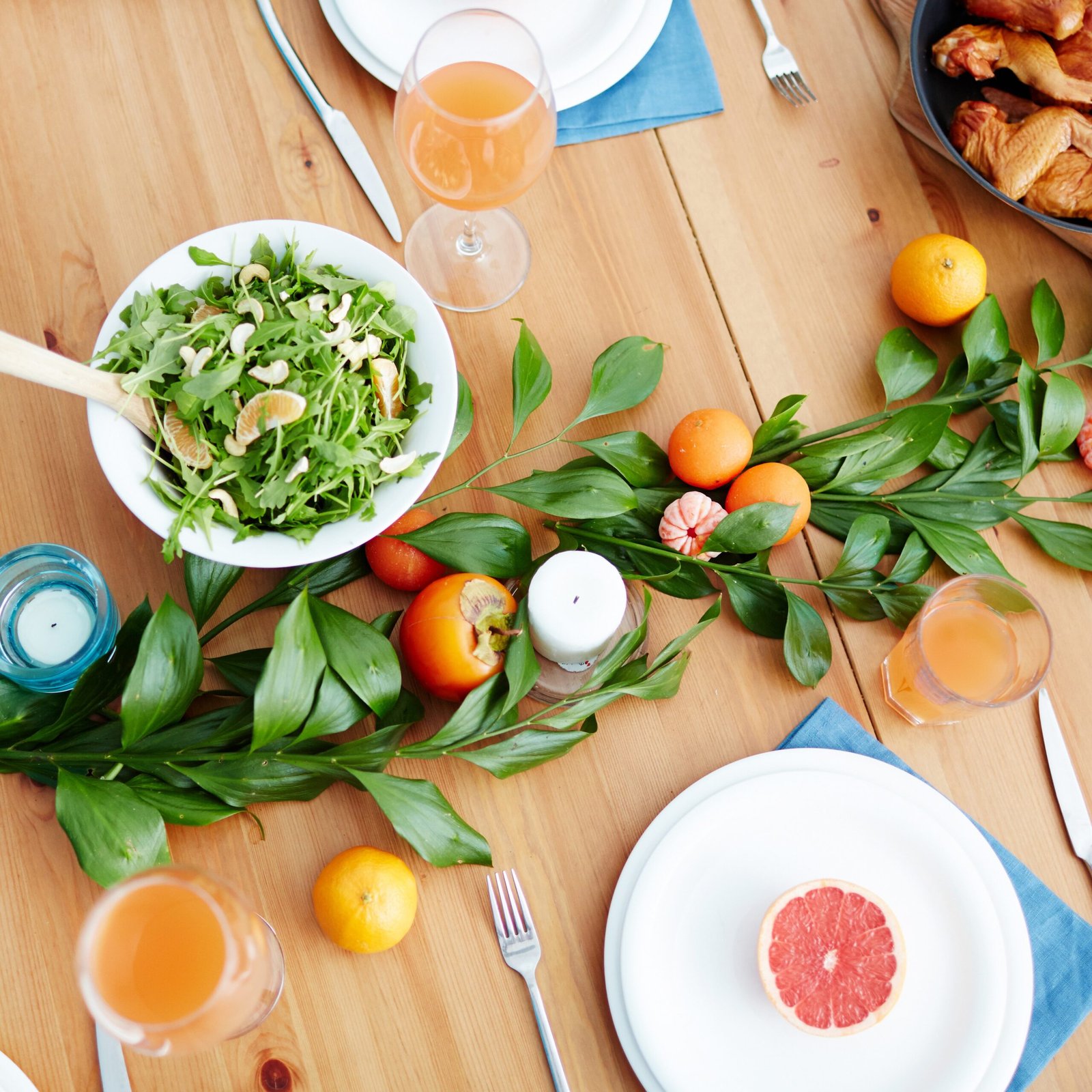 Served table beautifully decorated with leaves and fruit seen from above